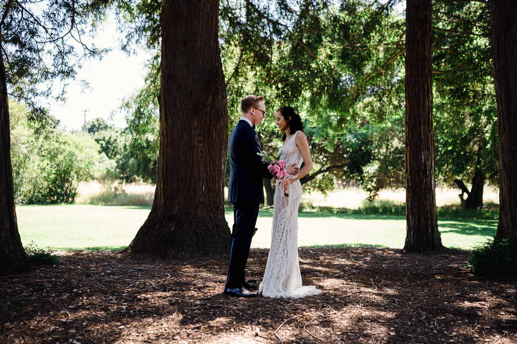 Intimate backyard wedding ceremony surrounded by lush greenery in Palo Alto, California.