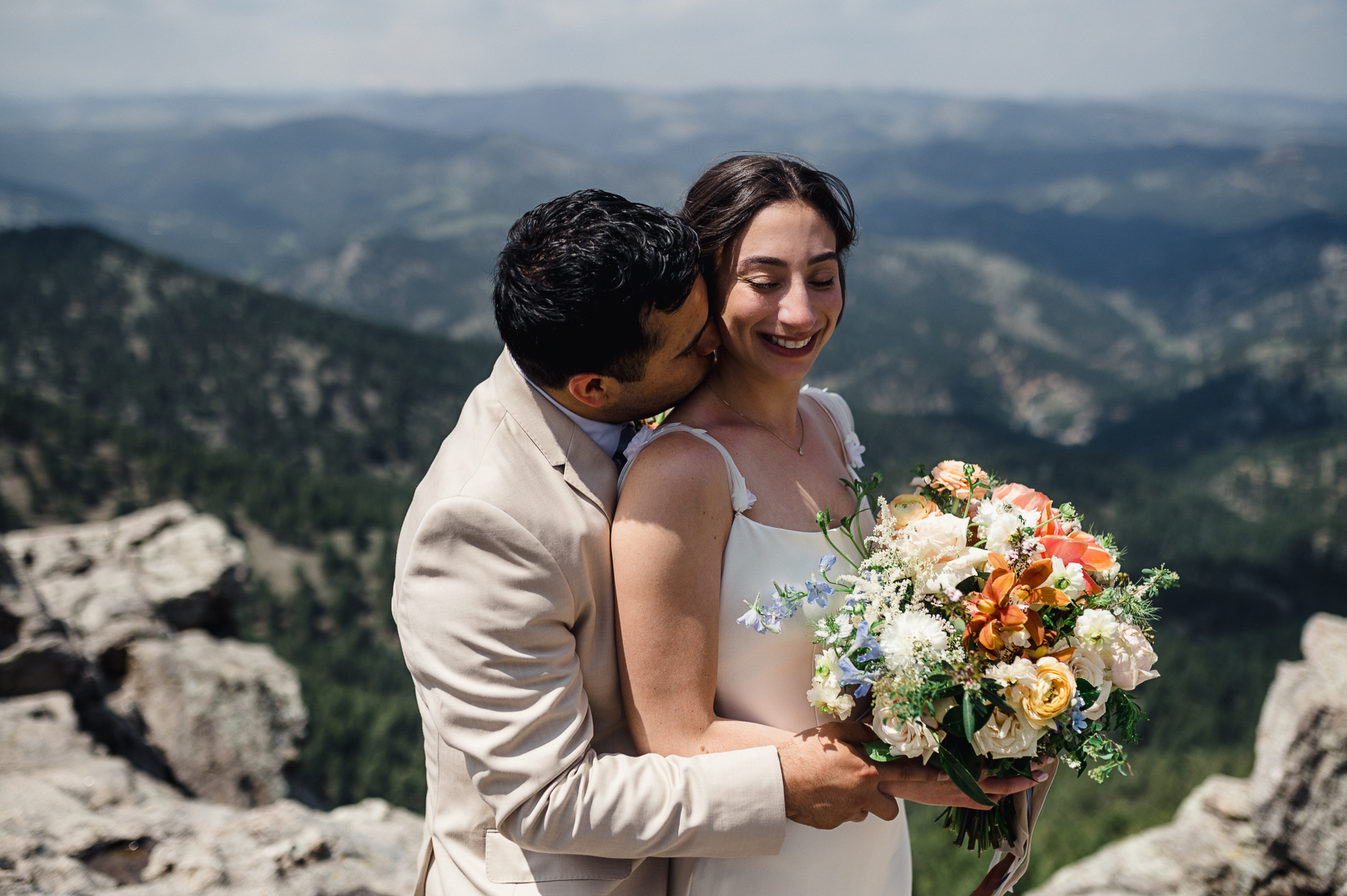 The sun setting over the breathtaking landscape of Boulder, Colorado, casting a golden glow on the venue where the couple celebrated their special day.