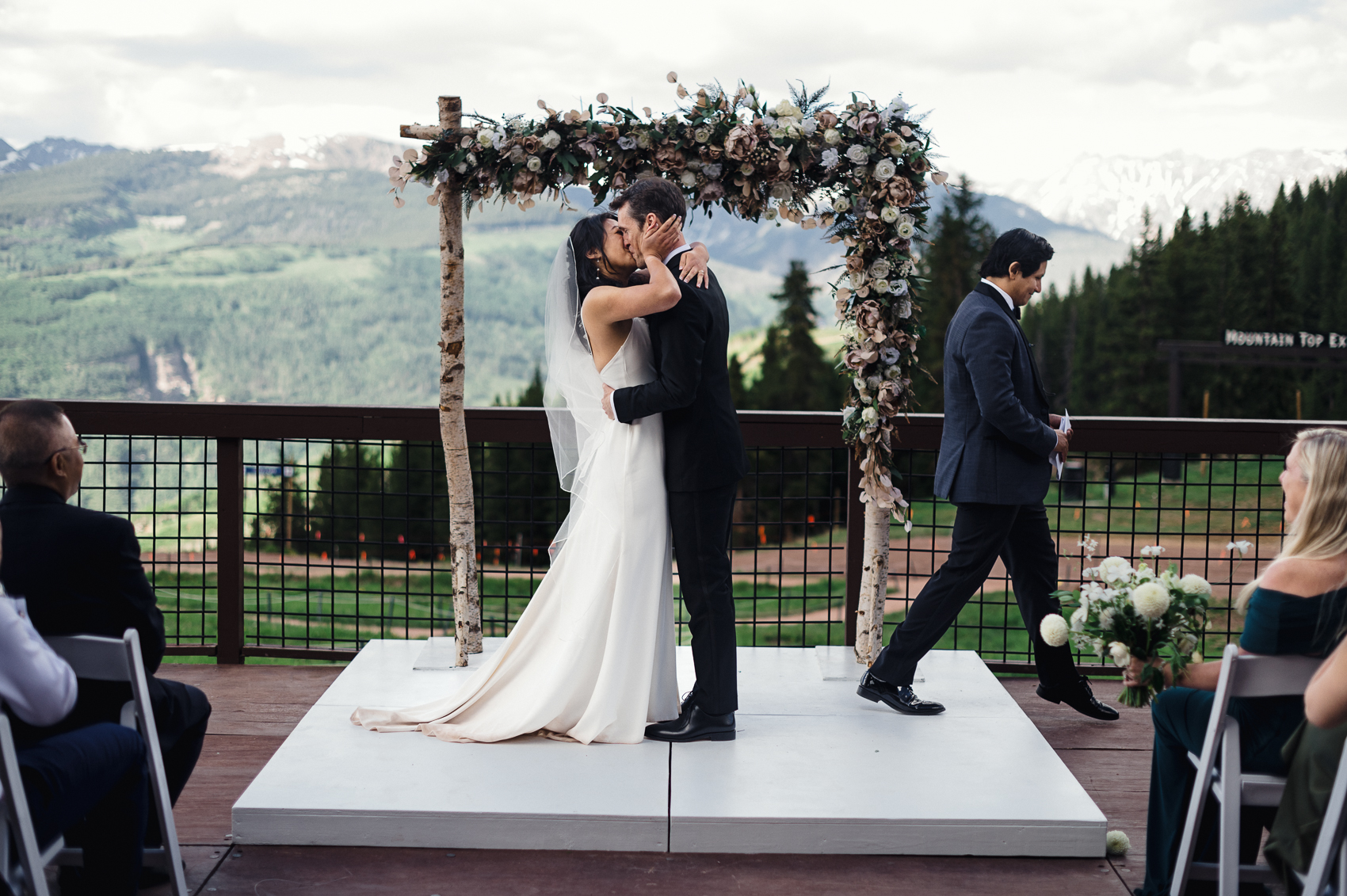 A stunning summer wedding ceremony at The 10th Vail, with the couple exchanging vows against a backdrop of breathtaking mountain views.