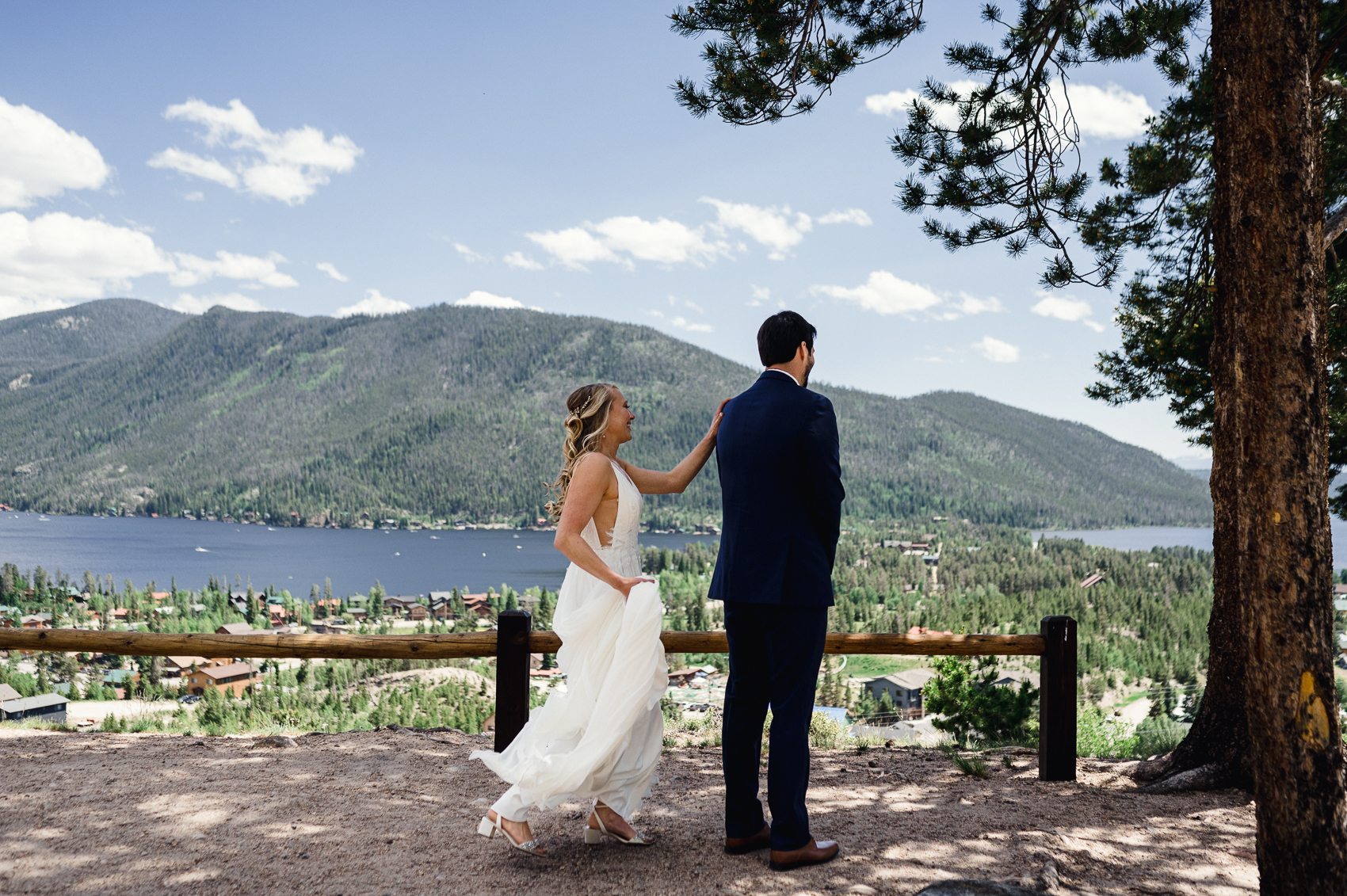 A couple sharing a first look in front of a stunning mountain backdrop at their Grand Lake Lodge wedding.