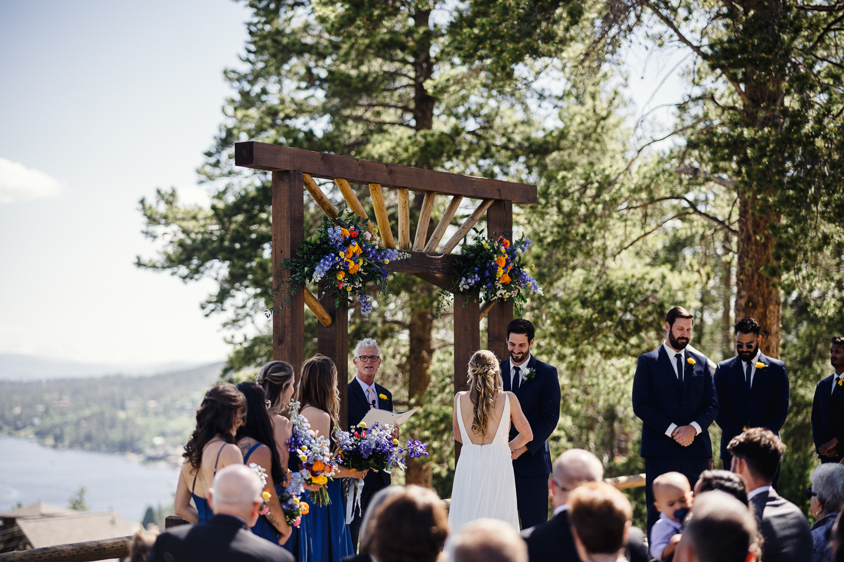 An outdoor wedding ceremony in front of a stunning mountain backdrop at their Grand Lake Lodge wedding.