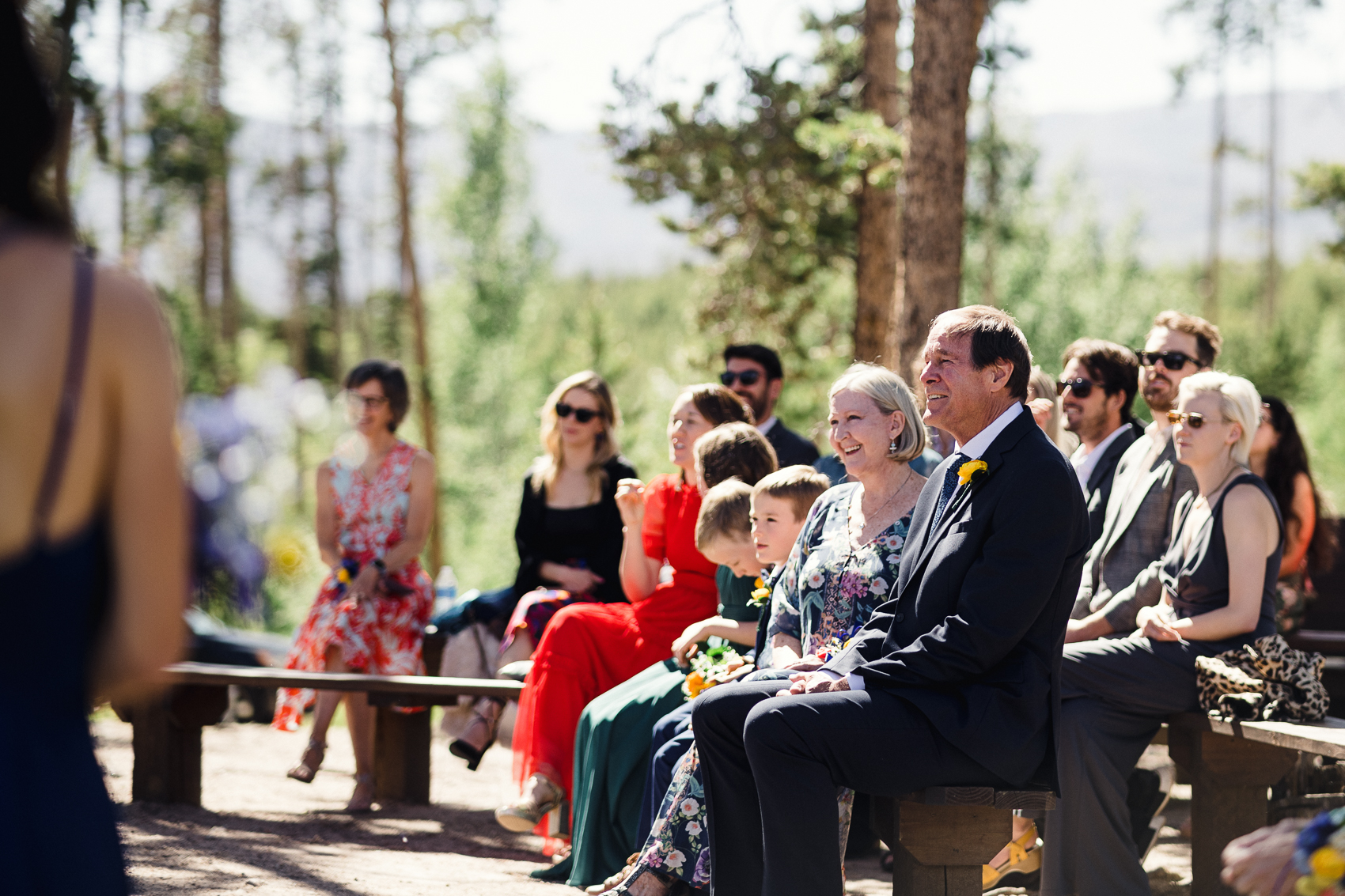 An outdoor wedding ceremony in front of a stunning mountain backdrop at their Grand Lake Lodge wedding.