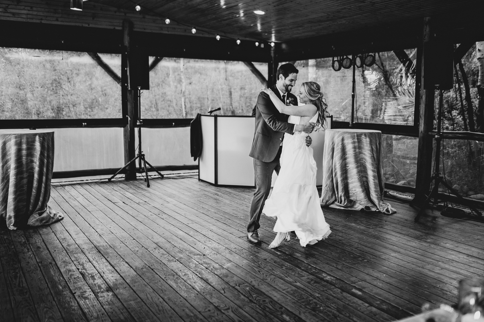 A couple shares a first dance at a wedding reception on the deck of Grand Lake Lodge.
