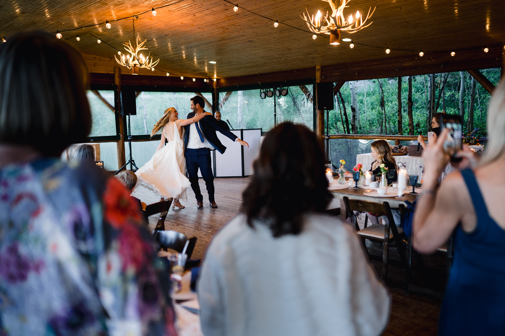 A couple shares a first dance at a wedding reception on the deck of Grand Lake Lodge.