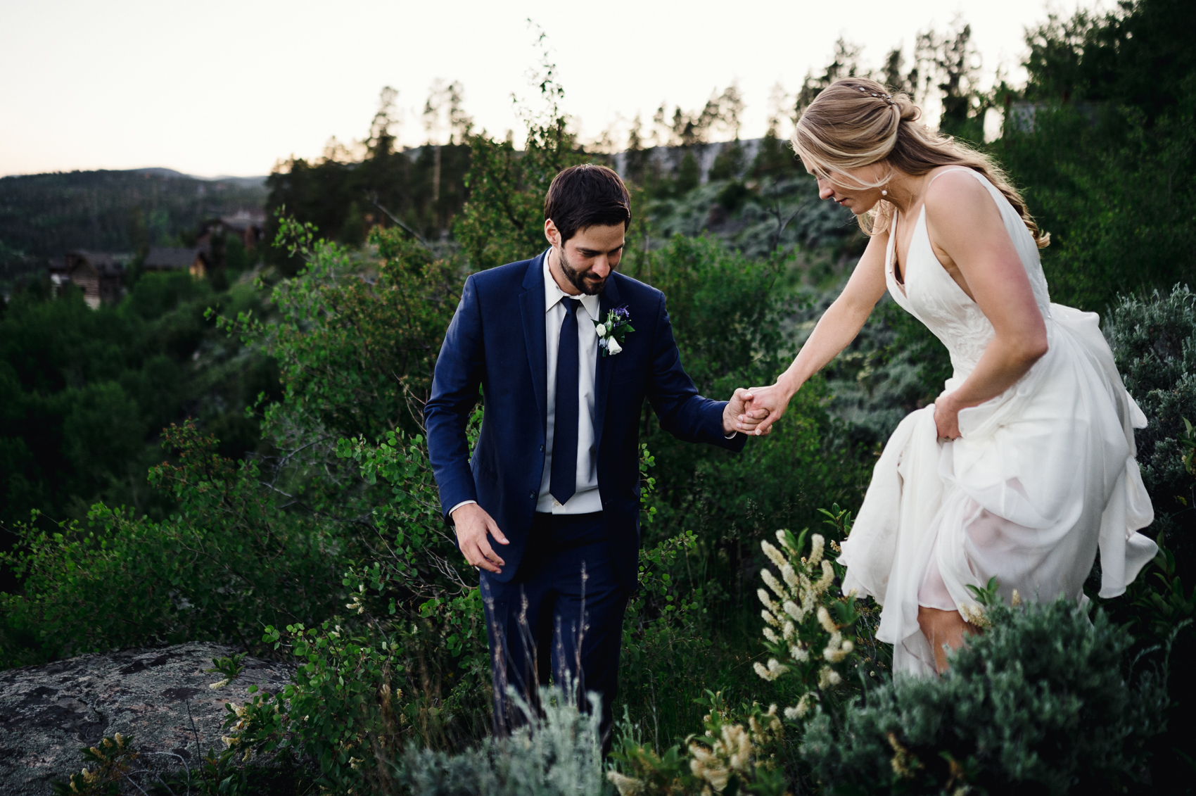 A couple sharing a first look in front of a stunning mountain backdrop at their Grand Lake Lodge wedding.