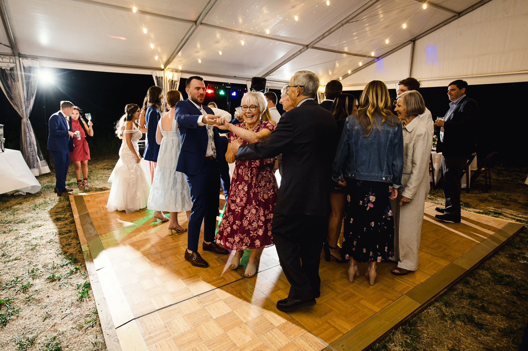 a summer reception under a white tent at a lynn britt cabin wedding